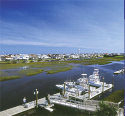 Yachts at a pier in Ocean Isle Beach's Intracoastal Waterway with a scenic view looking out across the water